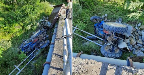 Traktori i ngarkuar me gurë bie nga ura